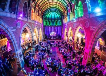Christmas party night at Empire Banqueting Hall Leicester — guests dining under the Grade II-listed vaulted ceiling with coloured production lighting